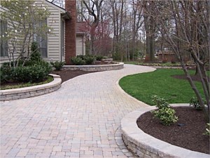 Paver walk leading to front door with low wall planter boxes